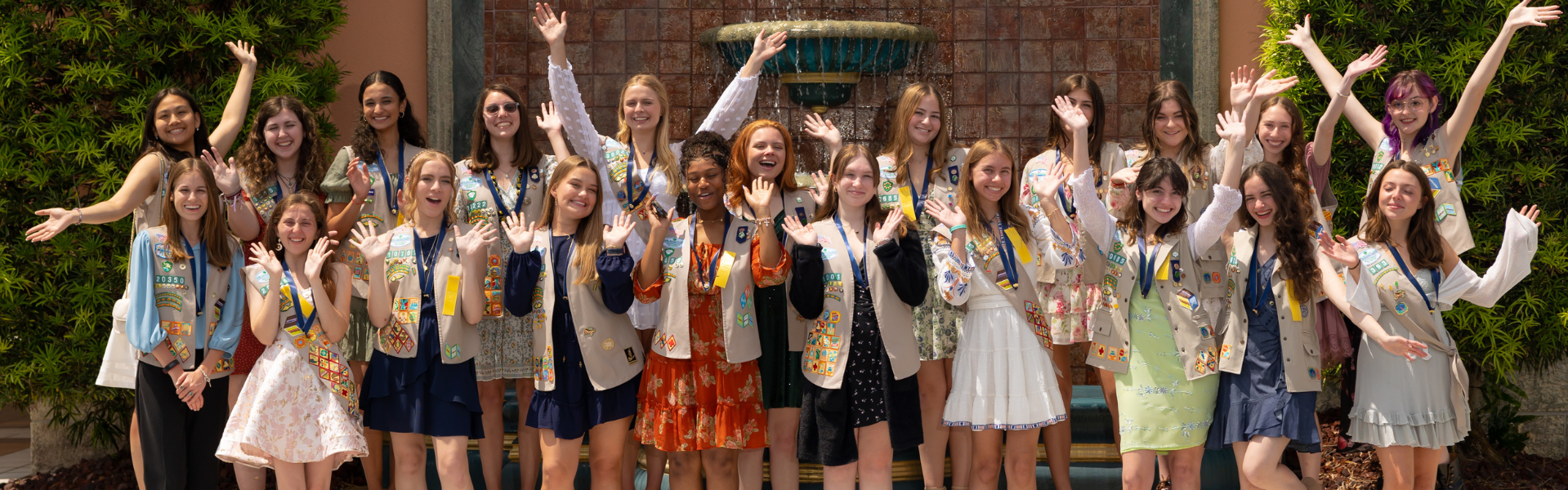 Group of teenage girls in vests celebrating 